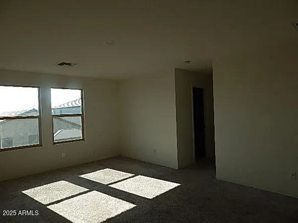a view of an empty room with windows