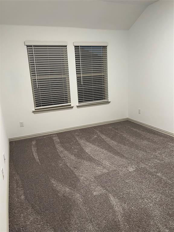 6041 Roper Road McKinney, TX 75070 - Photo 15 of 24 Carpeted interior space featuring white walls and a vaulted ceiling