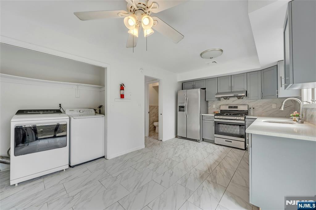 2410 3rd Street Fort Lee, NJ 07024 - Photo 13 of 37 a kitchen with a stove and a microwave