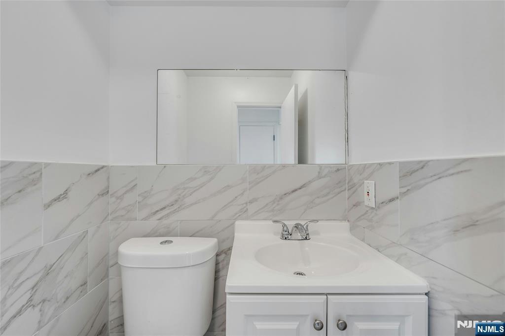2410 3rd Street Fort Lee, NJ 07024 - Photo 14 of 37 a bathroom with a sink and a toilet