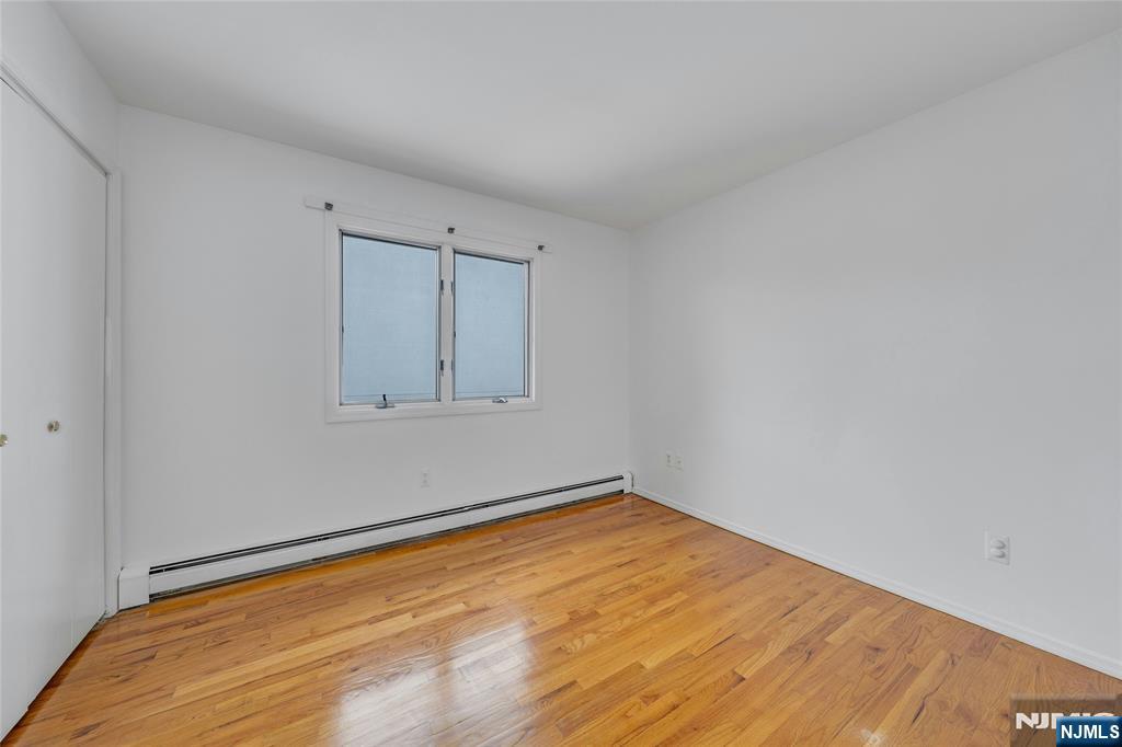 2410 3rd Street Fort Lee, NJ 07024 - Photo 20 of 37 a view of empty room with wooden floor