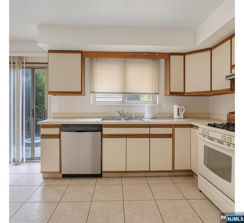 2410 3rd Street Fort Lee, NJ 07024 - Photo 30 of 37 a kitchen with granite countertop white cabinets and white appliances