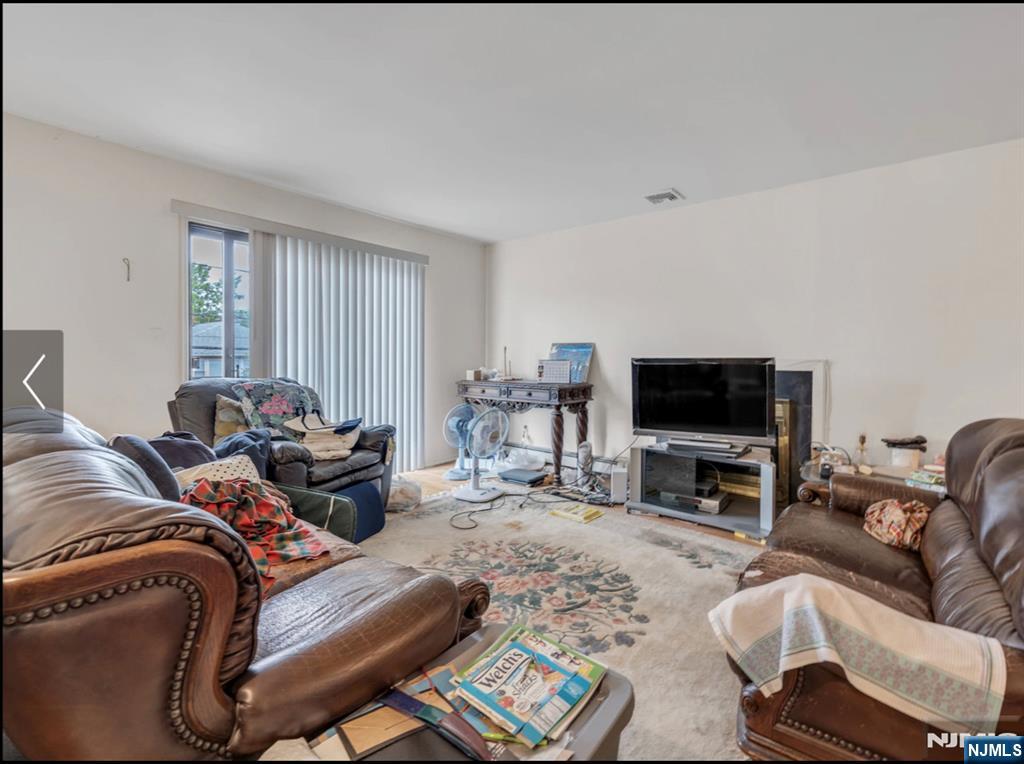 2410 3rd Street Fort Lee, NJ 07024 - Photo 36 of 37 a living room with furniture and a flat screen tv