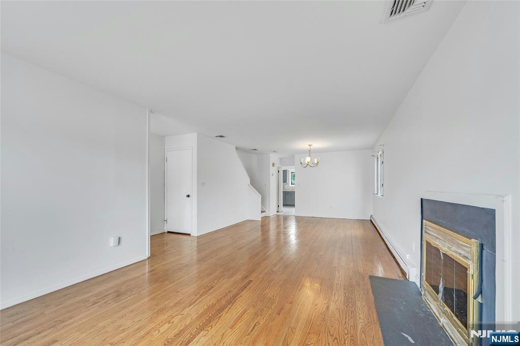 2410 3rd Street Fort Lee, NJ 07024 - Photo 4 of 37 a view of an empty room with wooden floor and a window