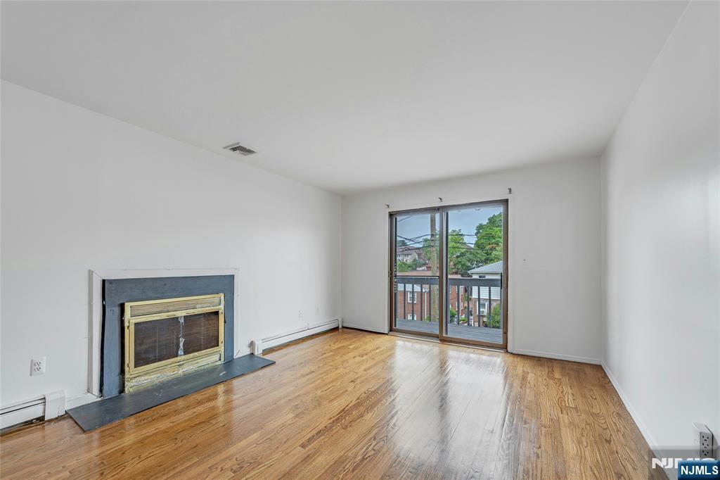 2410 3rd Street Fort Lee, NJ 07024 - Photo 5 of 37 an empty room with wooden floor and windows