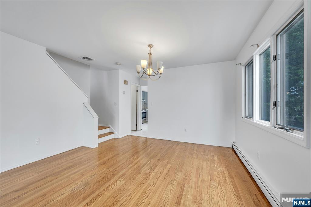 2410 3rd Street Fort Lee, NJ 07024 - Photo 7 of 37 a view of a room with wooden floor and chandelier