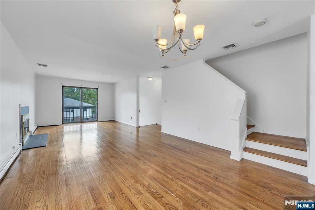 2410 3rd Street Fort Lee, NJ 07024 - Photo 8 of 37 a view of an empty room with wooden floor and window