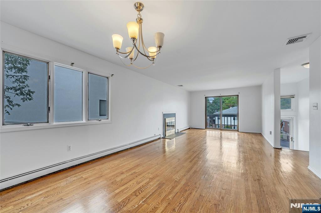 2410 3rd Street Fort Lee, NJ 07024 - Photo 9 of 37 a view of an empty room with wooden floor and a window