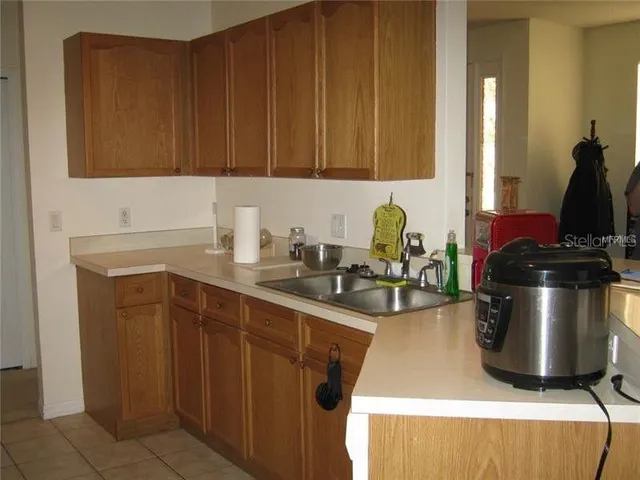 a kitchen with a sink cabinets and appliances