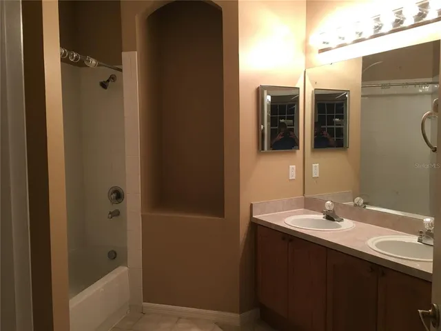 a bathroom with a sink a mirror and shower