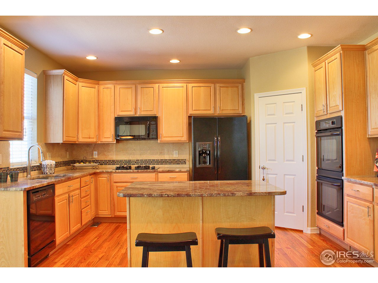 4393 Rabbit Mountain Road Broomfield, CO 80020 - Photo 7 of 23 Gourmet style kitchen with oversized maple cabs