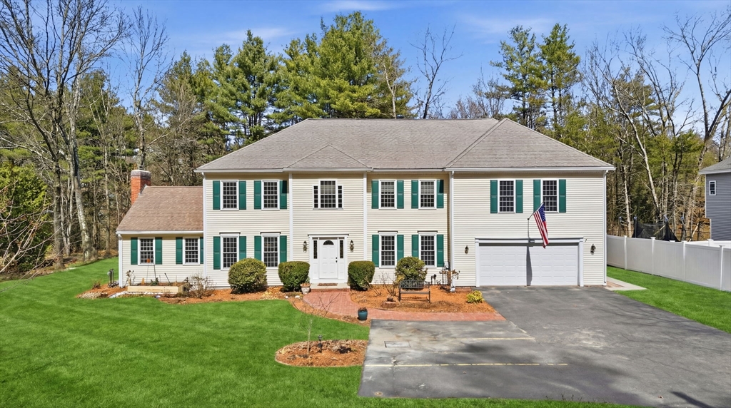 a front view of a house with a yard table and chairs