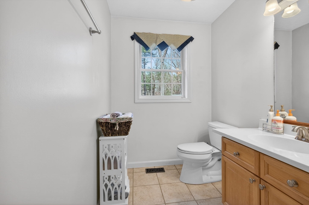 155 Brook Street Hudson, MA 01749 - Photo 14 of 42 a bathroom with a toilet a sink and a mirror