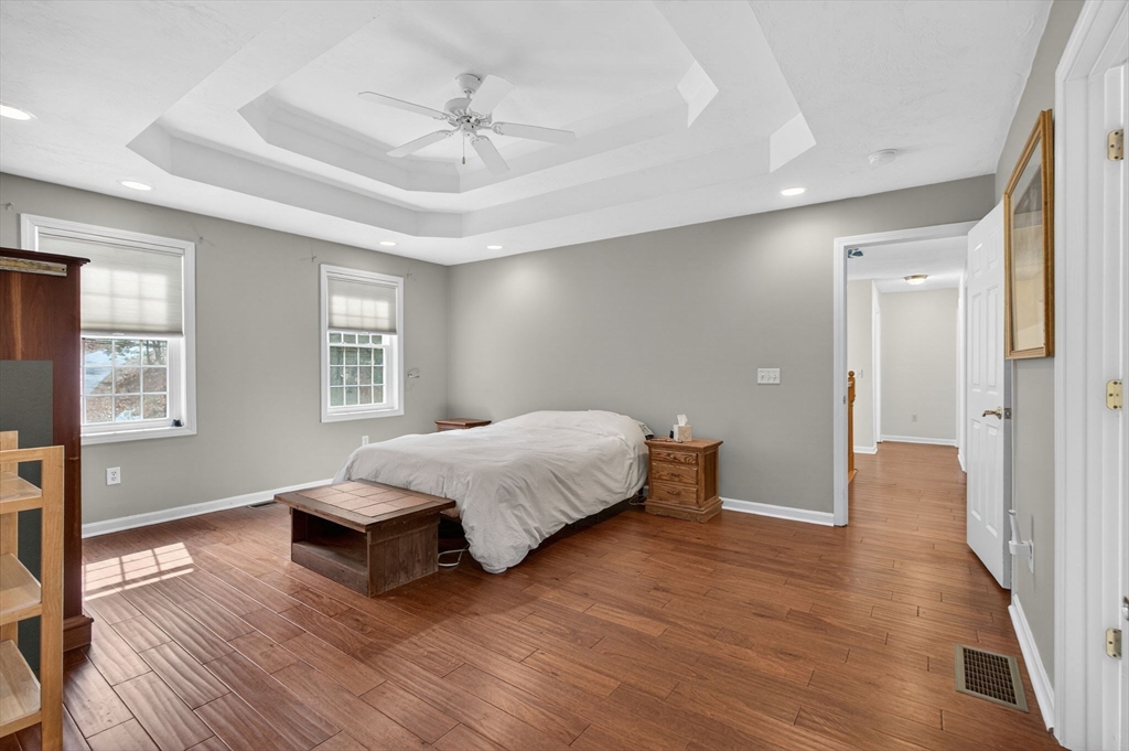 155 Brook Street Hudson, MA 01749 - Photo 17 of 42 a spacious bedroom with a bed and wooden floor