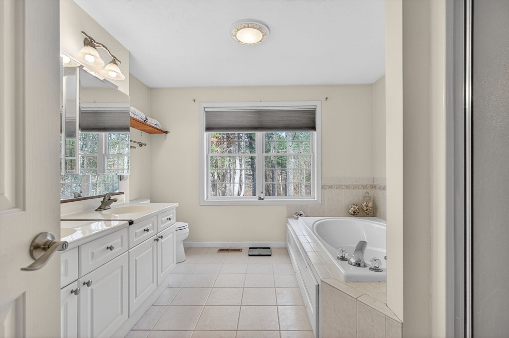 155 Brook Street Hudson, MA 01749 - Photo 19 of 42 a bathroom with a tub sink and mirror