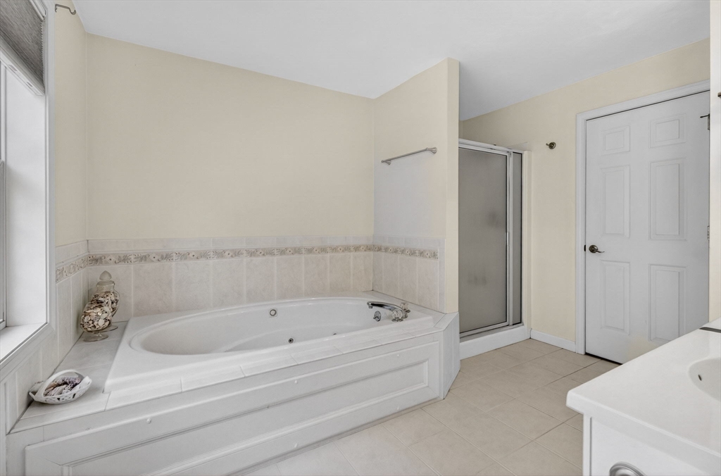 155 Brook Street Hudson, MA 01749 - Photo 20 of 42 a bathroom with a tub and shower