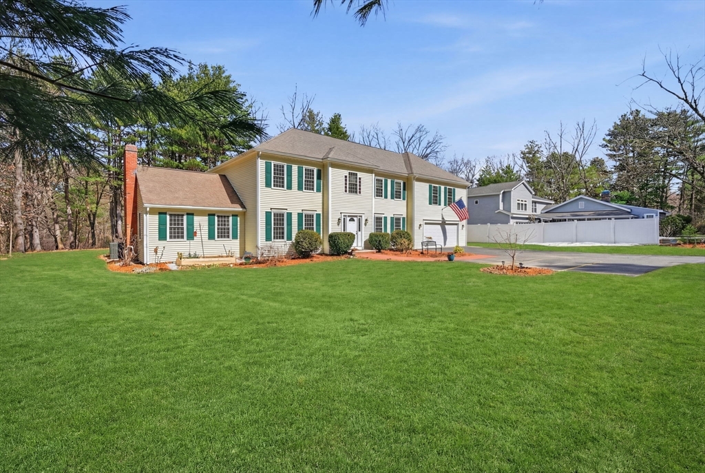 155 Brook Street Hudson, MA 01749 - Photo 2 of 42 a front view of a house with a garden
