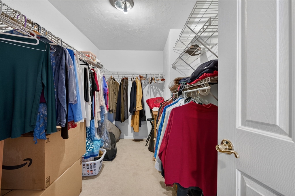 155 Brook Street Hudson, MA 01749 - Photo 21 of 42 a view of walk in closet with clothes