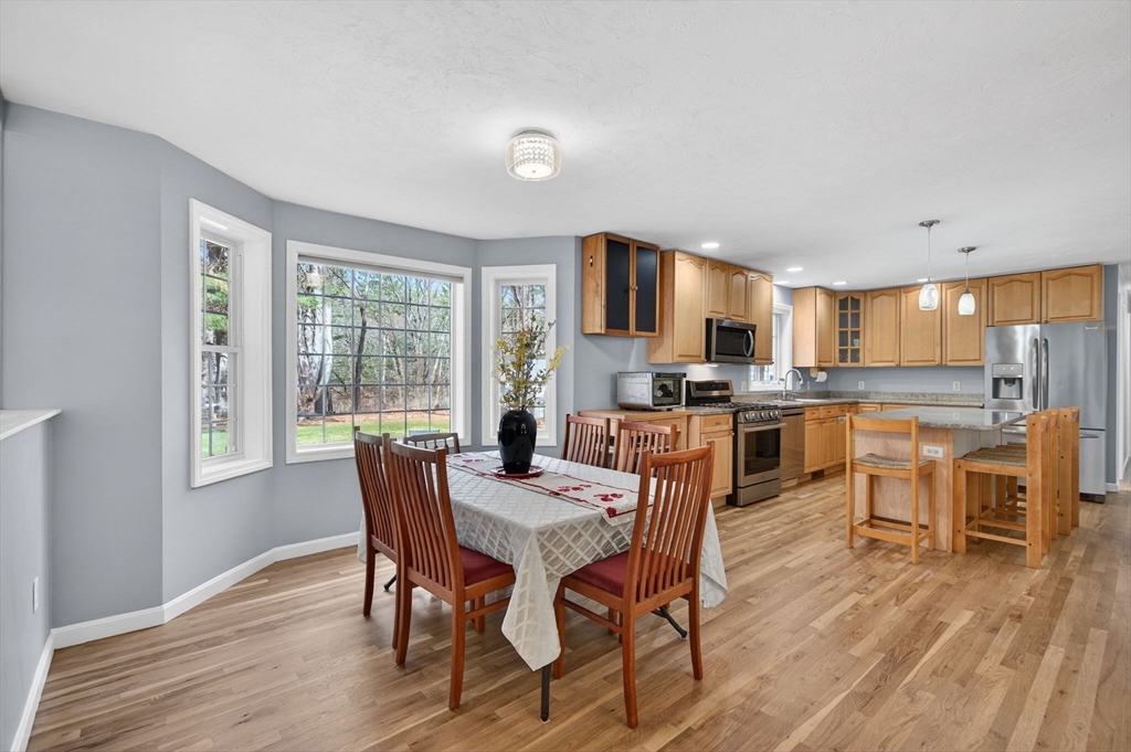 155 Brook Street Hudson, MA 01749 - Photo 5 of 42 a view of a dining room with furniture and wooden floor