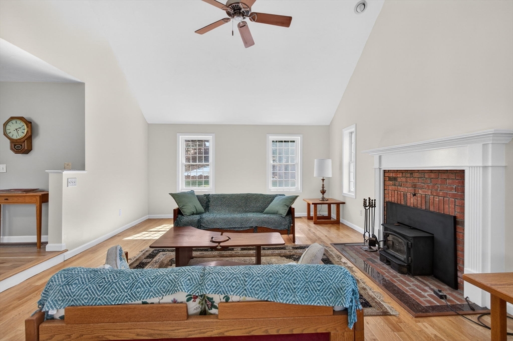 155 Brook Street Hudson, MA 01749 - Photo 10 of 42 a living room with furniture and a fireplace