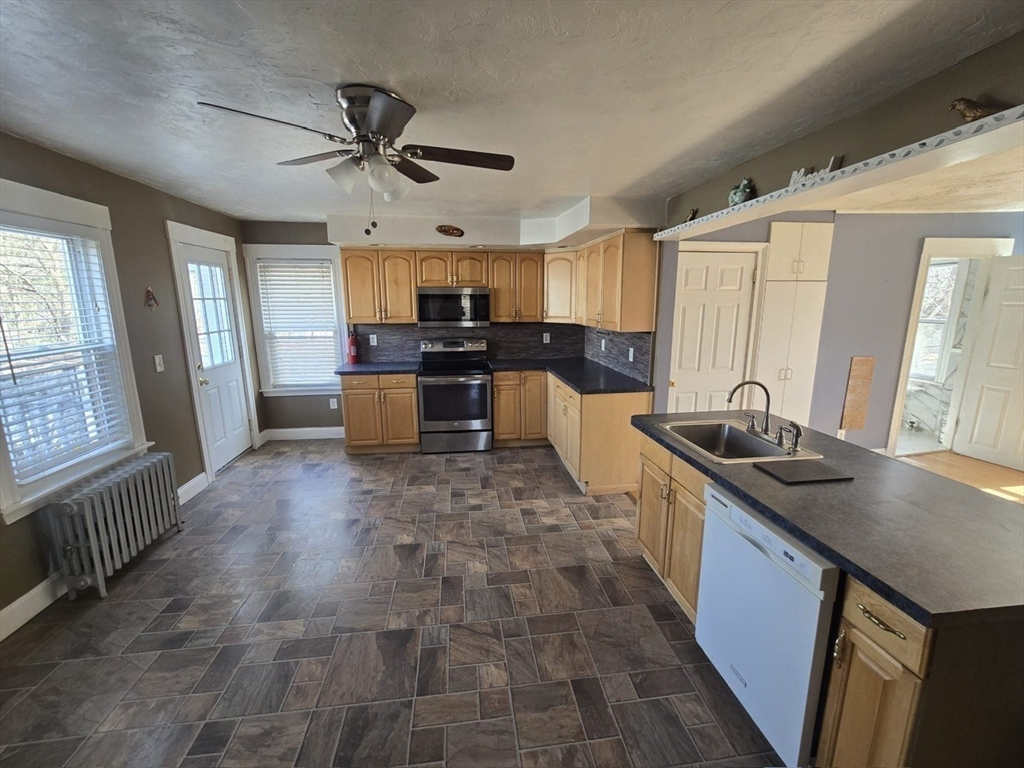14 Chestnut Avenue, Unit 2 Auburn, MA 01501 - Photo 12 of 41 a kitchen with a stove a sink and a refrigerator
