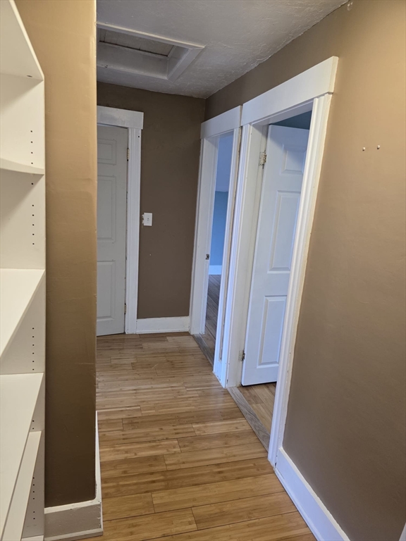 14 Chestnut Avenue, Unit 2 Auburn, MA 01501 - Photo 14 of 41 a view of a hallway with wooden floor and closet