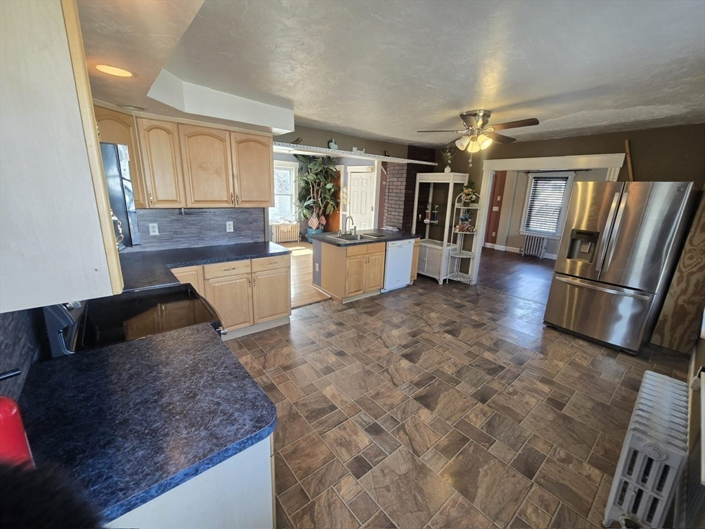 14 Chestnut Avenue, Unit 2 Auburn, MA 01501 - Photo 18 of 41 a living room with stainless steel appliances furniture a refrigerator and a kitchen view