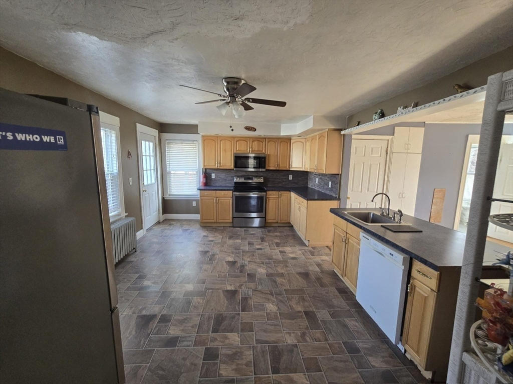 14 Chestnut Avenue, Unit 2 Auburn, MA 01501 - Photo 20 of 41 a large kitchen with stainless steel appliances granite countertop a stove refrigerator and a sink
