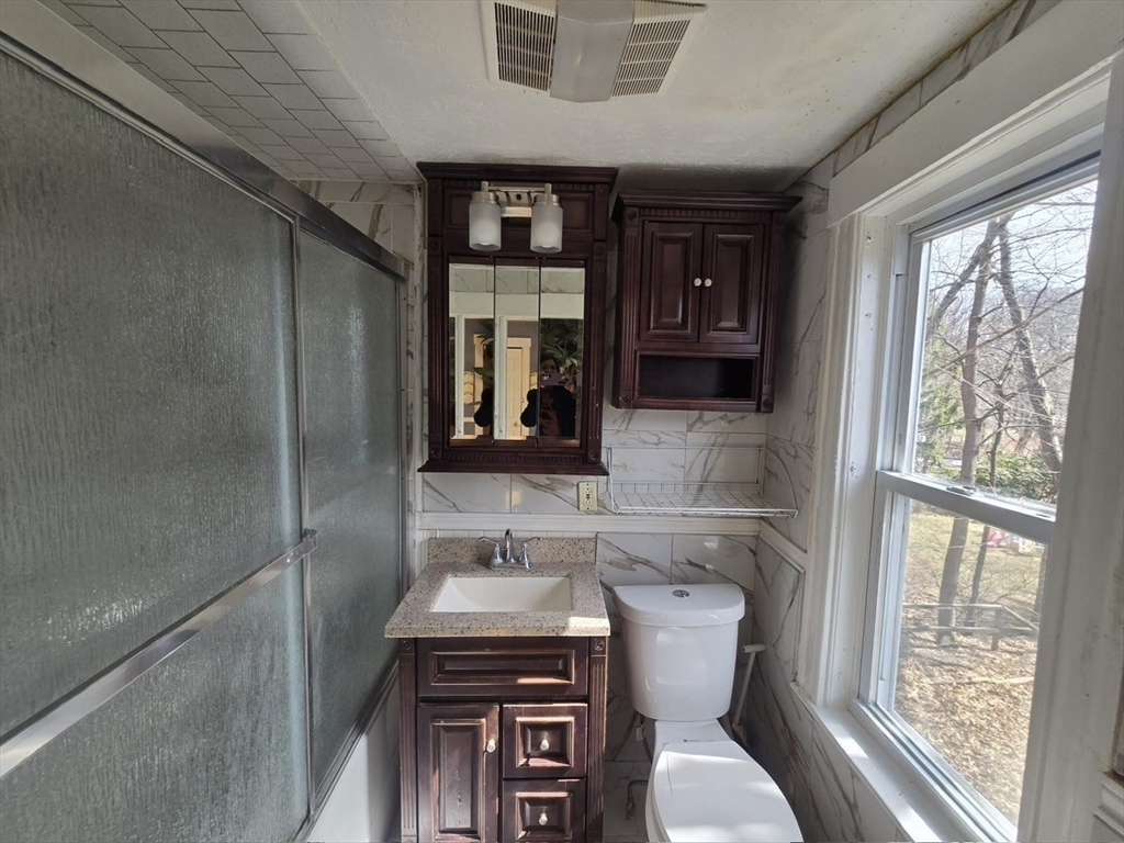 14 Chestnut Avenue, Unit 2 Auburn, MA 01501 - Photo 21 of 41 a bathroom with a toilet sink and mirror