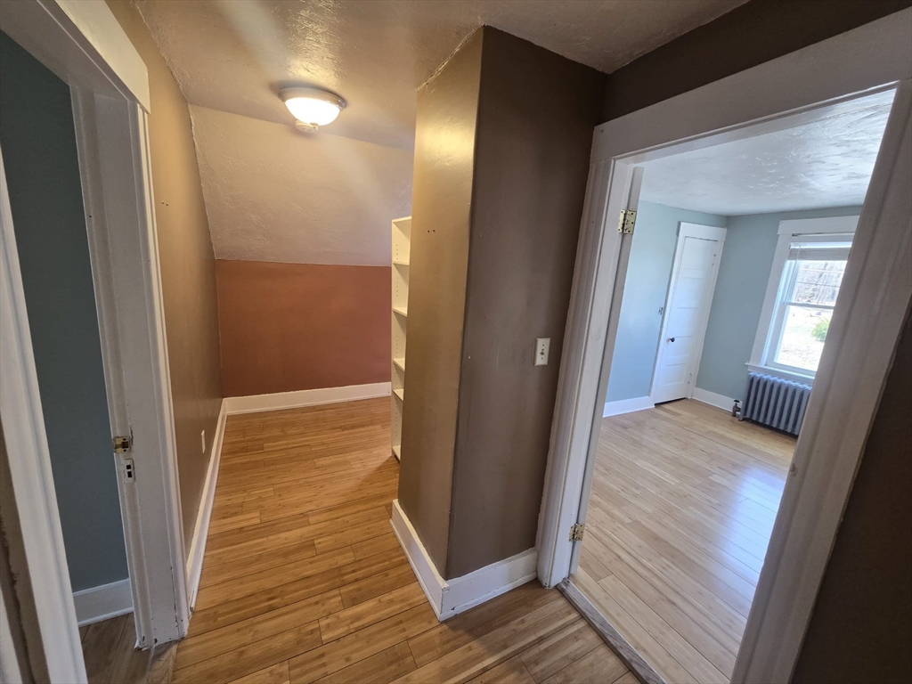 14 Chestnut Avenue, Unit 2 Auburn, MA 01501 - Photo 25 of 41 a view of a hallway with wooden floor and staircase