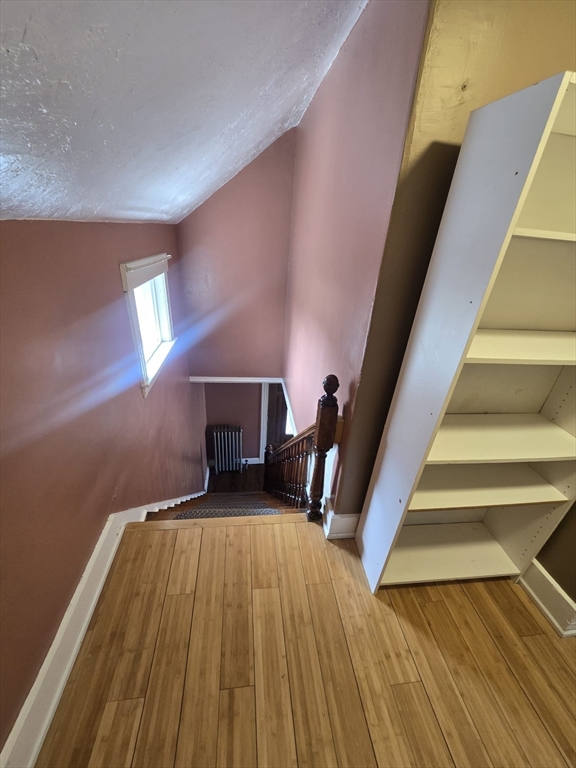 14 Chestnut Avenue, Unit 2 Auburn, MA 01501 - Photo 27 of 41 a view of a room with wooden floor and staircase