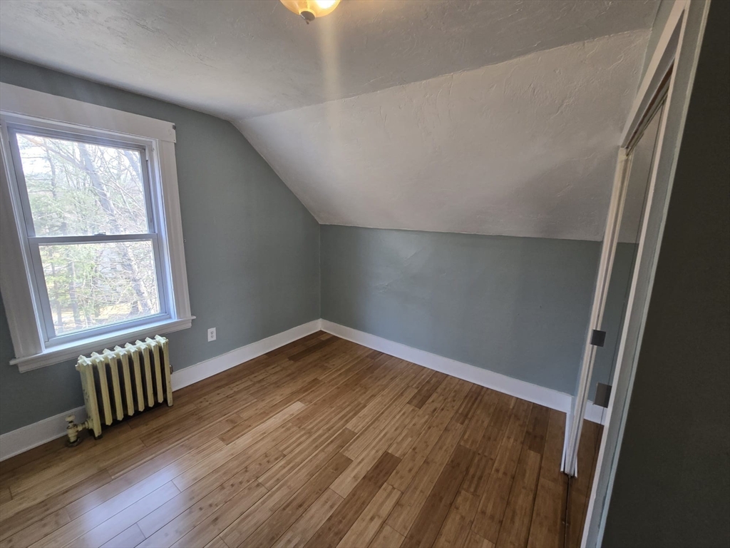 14 Chestnut Avenue, Unit 2 Auburn, MA 01501 - Photo 30 of 41 an empty room with wooden floor and windows