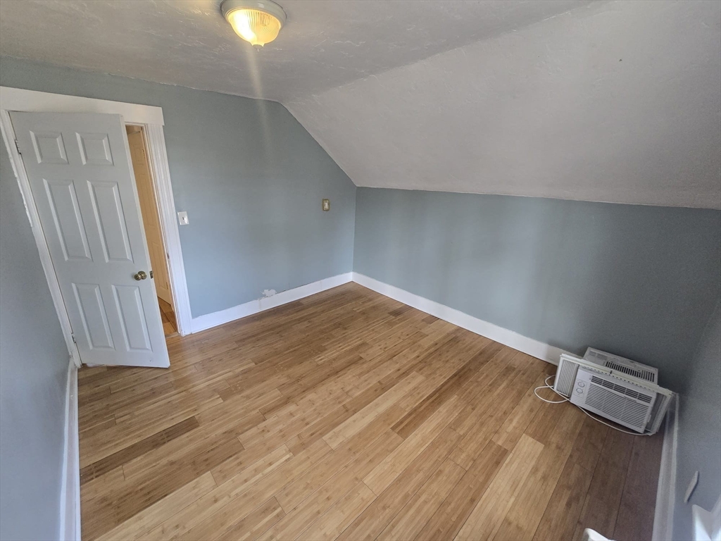 14 Chestnut Avenue, Unit 2 Auburn, MA 01501 - Photo 33 of 41 an empty room with wooden floor and windows