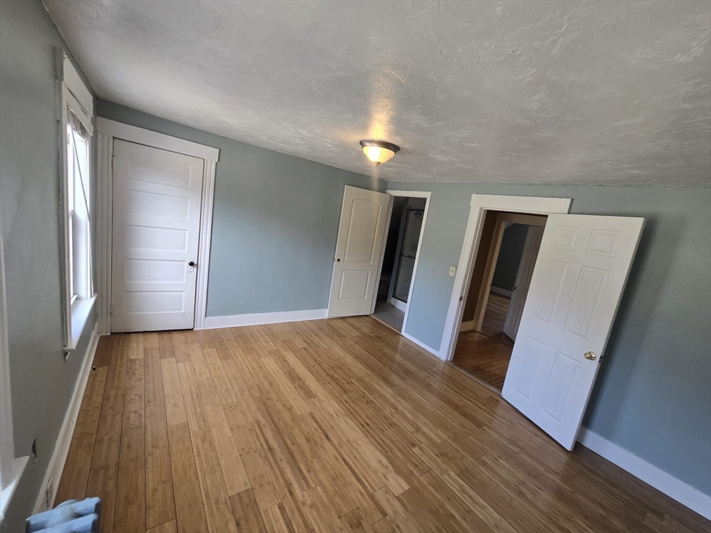 14 Chestnut Avenue, Unit 2 Auburn, MA 01501 - Photo 39 of 41 a view of a room with wooden floor and staircase