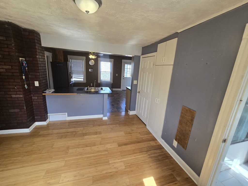 14 Chestnut Avenue, Unit 2 Auburn, MA 01501 - Photo 10 of 41 a view of a kitchen with furniture and wooden floor