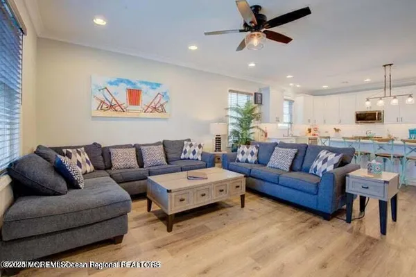 a view of a living room kitchen and a wooden floor