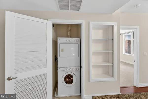 a view of a kitchen with wooden floor and a sink