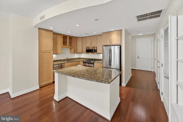 a view of a kitchen with wooden floor and a kitchen