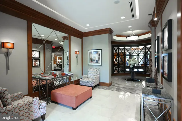 a living room with furniture a large window and a chandelier