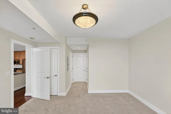 an empty room with windows and closet