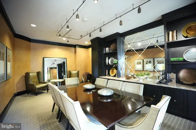 a living room with fireplace furniture and a chandelier