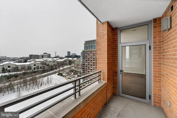 a living room with furniture a large window and a chandelier