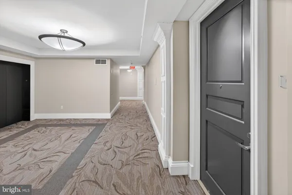 a view of a door and wooden floor