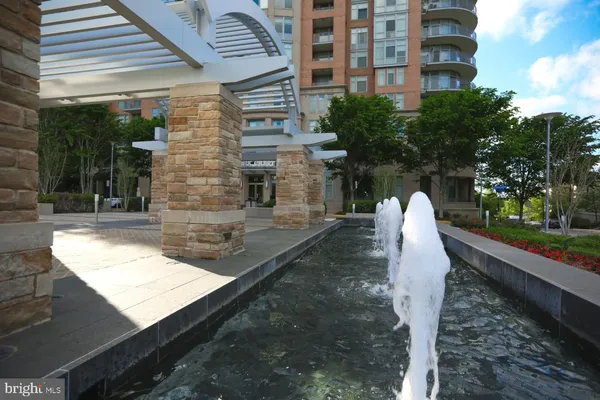 a living room with fireplace furniture and a chandelier