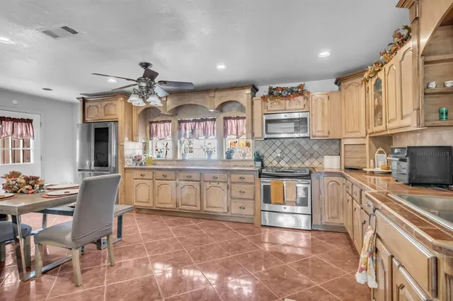 a kitchen with stainless steel appliances granite countertop a stove and cabinets