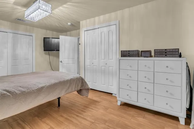 a large bed sitting in a bedroom next to a shower