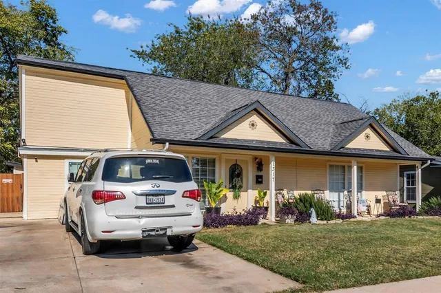 a view of a white house with a sink and garden