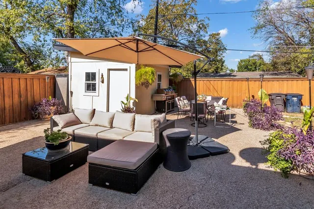 a view of a patio with table and chairs potted plants