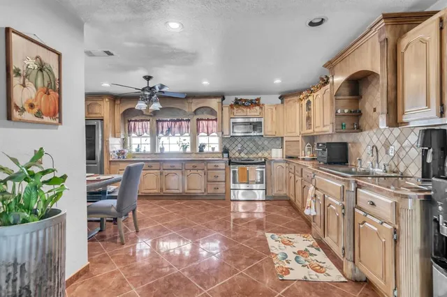 a large kitchen with kitchen island granite countertop lots of counter top space and dining table