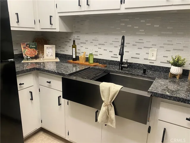 a kitchen with a sink and cabinets